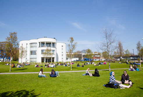 White Queen Mother Building with campus green in front