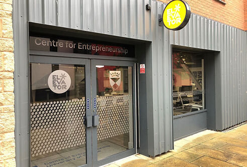 a grey shop front with double glass doors