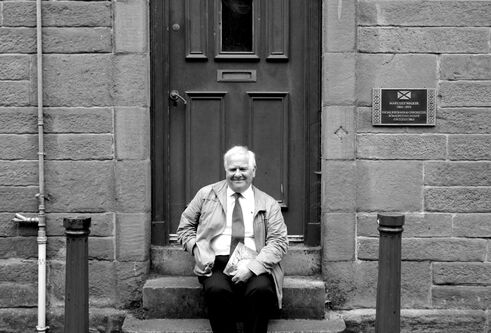 Eddie Small sat on the steps of Mary Lily Walker's house