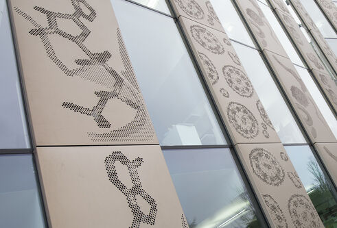 photograph of the side of the Discovery Building featuring the Scales of Life art collaboration