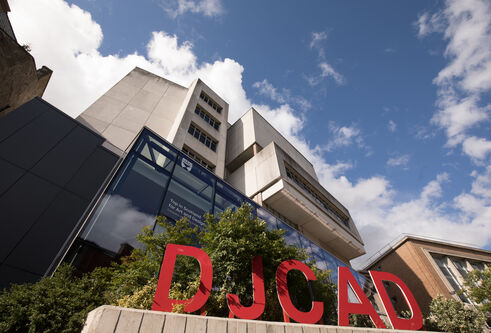 exterior of building with large red letters DJCAD