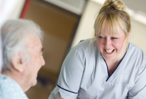 a nurse attending to an old man