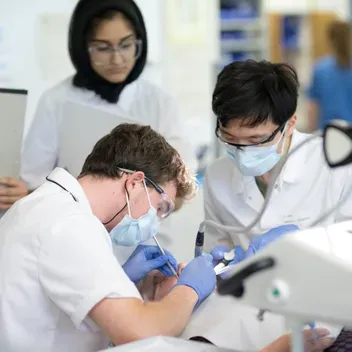Dentistry students wearing protective masks and glasses performing clinical skills at Dundee.
