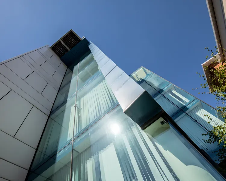 University of Dundee campus building, shot from below looking upwards into a blue sky