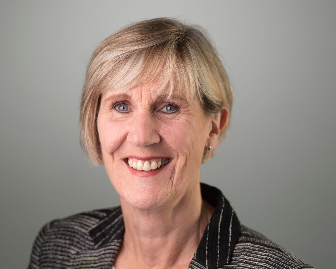 middle aged woman posing withj smile