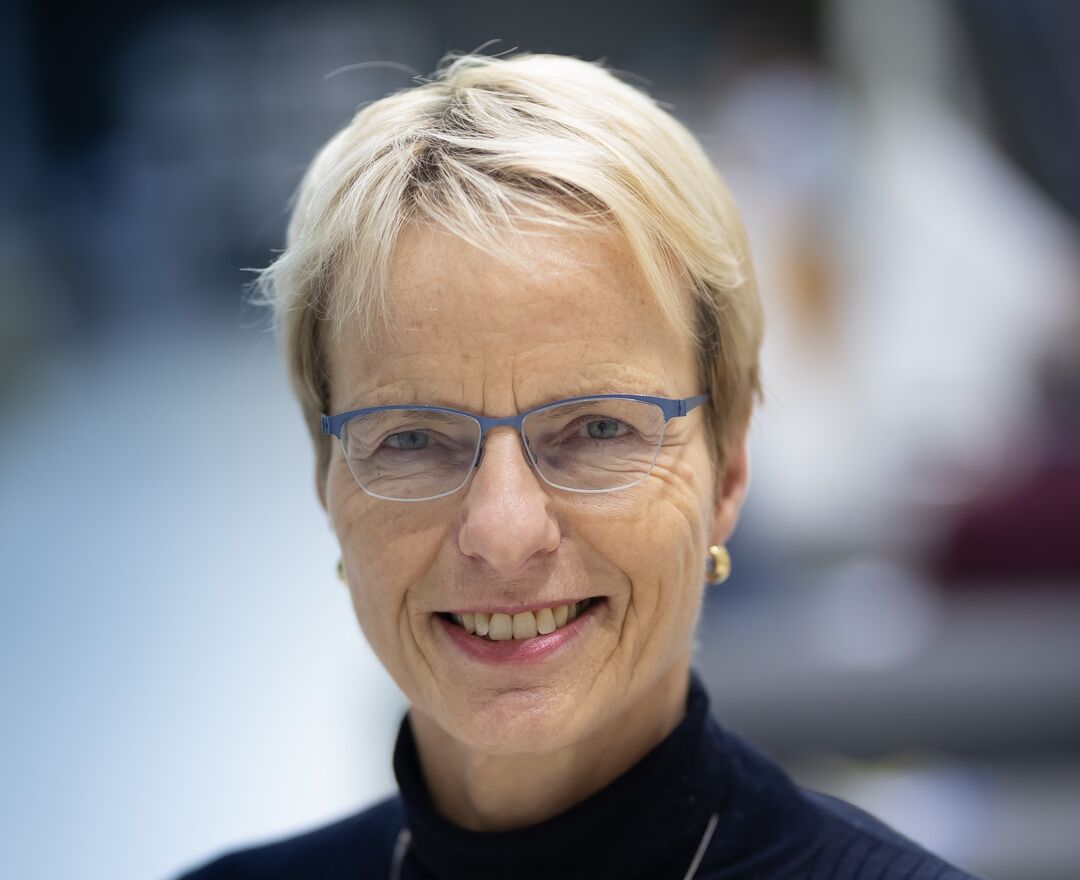 Picture of woman with glasses smiling at camera